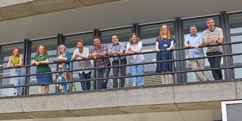 Our Faculty Librarian Team of 10 people, posing on the library balcony